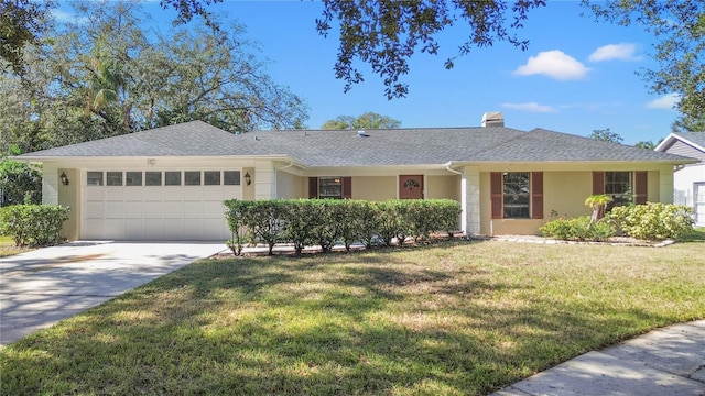 ranch-style house featuring a garage and a front lawn