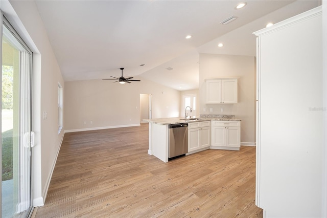 kitchen with white cabinetry, sink, stainless steel dishwasher, kitchen peninsula, and lofted ceiling