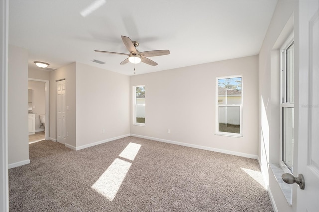 carpeted empty room featuring ceiling fan