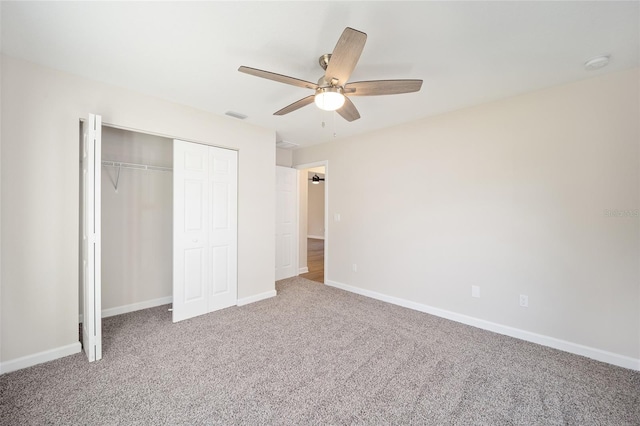 unfurnished bedroom featuring carpet flooring, a closet, and ceiling fan