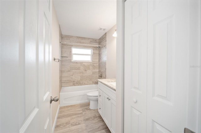 full bathroom with vanity, toilet, and tiled shower / bath