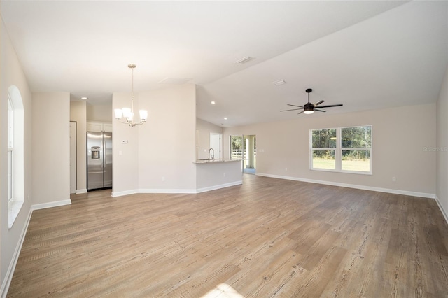 unfurnished living room featuring vaulted ceiling, sink, ceiling fan with notable chandelier, and light wood-type flooring