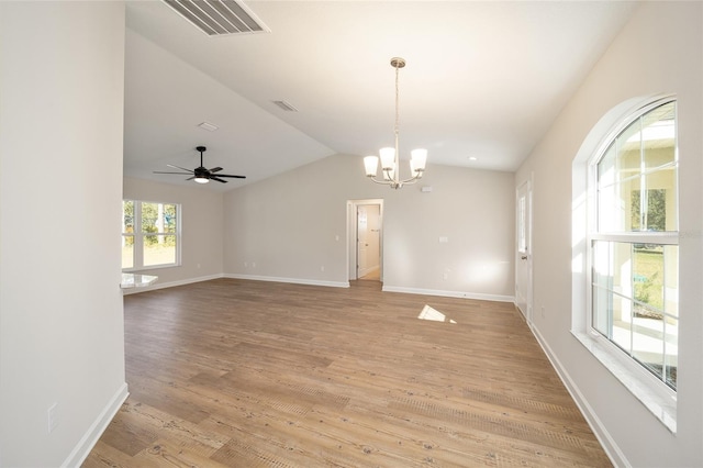 unfurnished room with vaulted ceiling, light hardwood / wood-style floors, and ceiling fan with notable chandelier