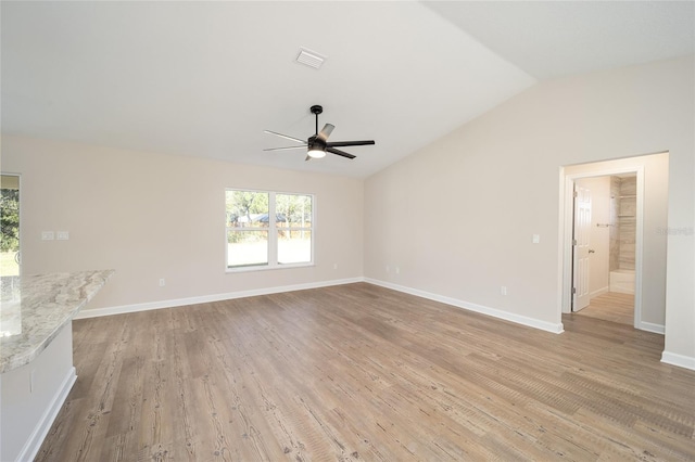 unfurnished living room featuring vaulted ceiling, light hardwood / wood-style flooring, and ceiling fan