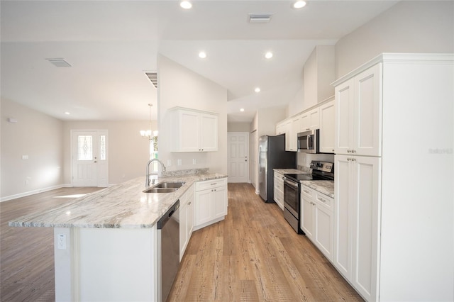 kitchen featuring light wood-type flooring, white cabinetry, sink, and appliances with stainless steel finishes