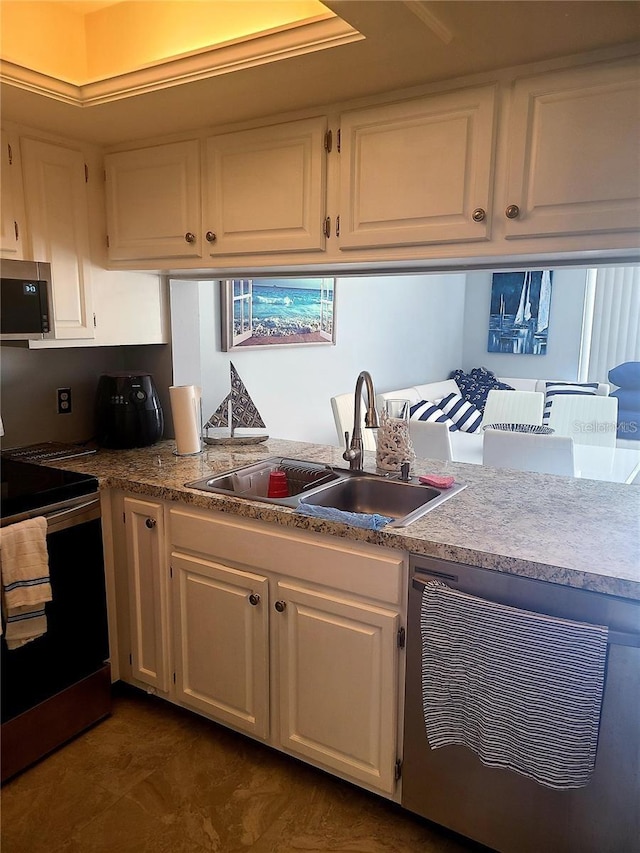 kitchen with white cabinets, black range with electric cooktop, and sink