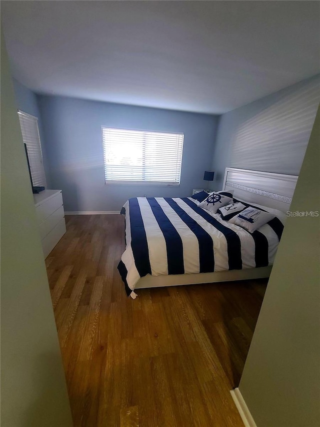 unfurnished bedroom with dark wood-type flooring