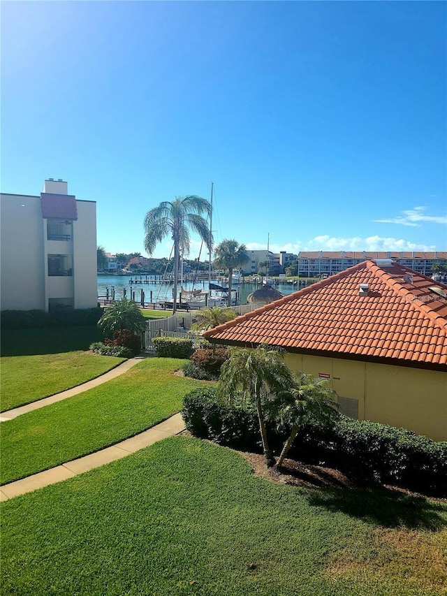 exterior space featuring a yard and a water view