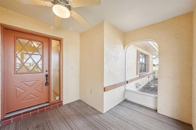 property entrance featuring ceiling fan