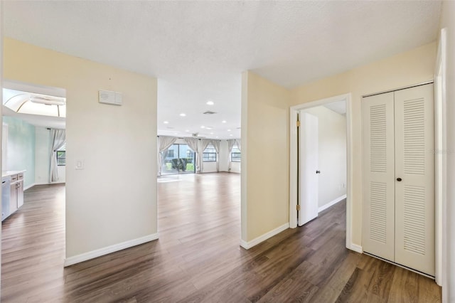 hall featuring dark hardwood / wood-style flooring and a textured ceiling