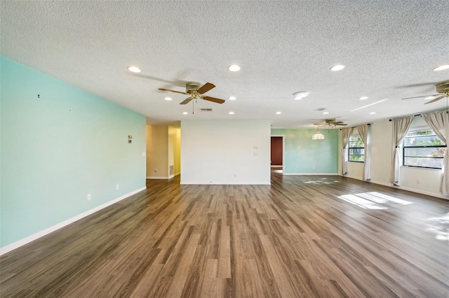 unfurnished living room featuring ceiling fan, a textured ceiling, and hardwood / wood-style flooring