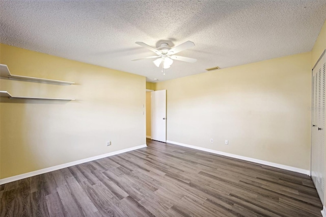 unfurnished bedroom with ceiling fan, wood-type flooring, a textured ceiling, and a closet