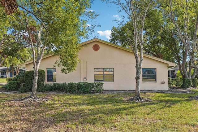 view of property exterior with a yard