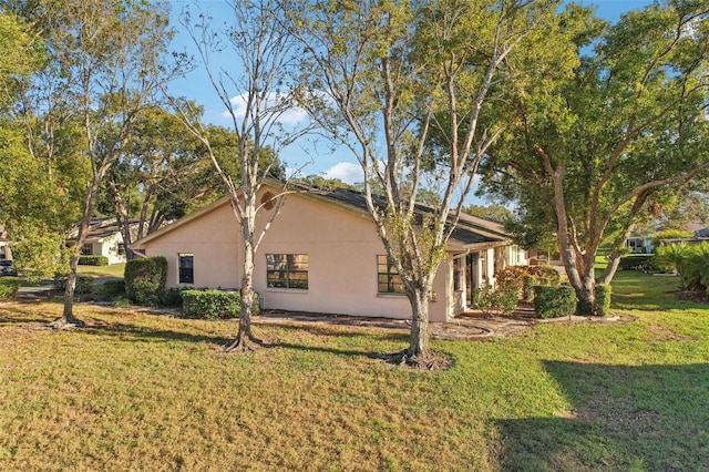 view of side of home featuring a lawn