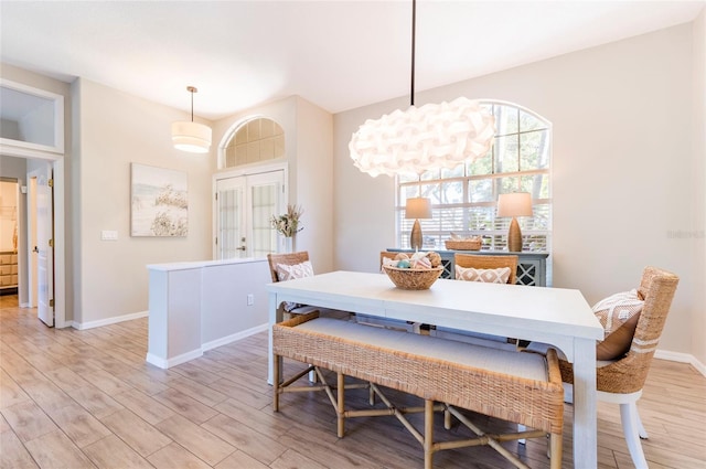 dining area featuring french doors and light hardwood / wood-style flooring