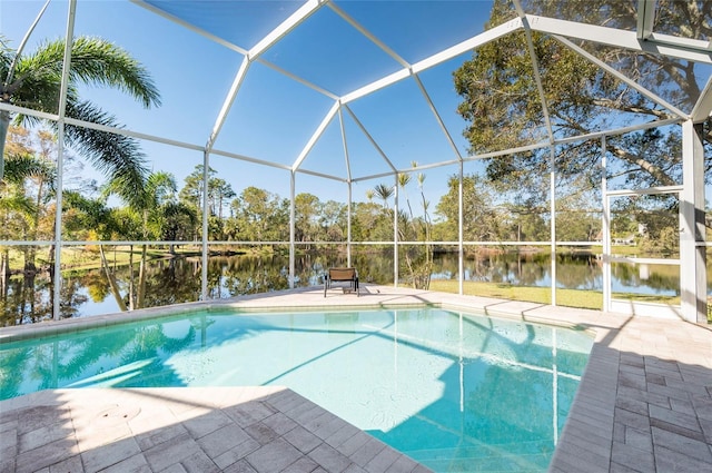 view of swimming pool with a lanai, a patio area, and a water view