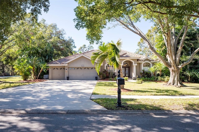 view of front of house with a garage and a front yard