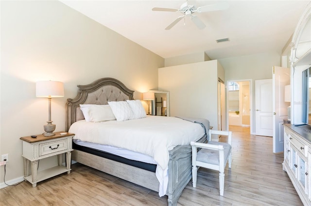 bedroom featuring ceiling fan, ensuite bath, and light hardwood / wood-style flooring