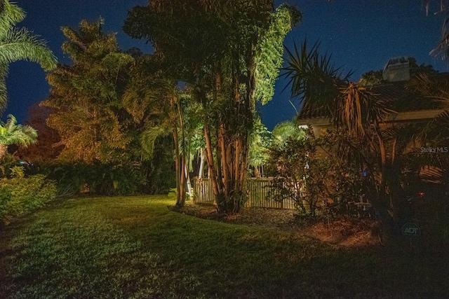 view of yard at twilight