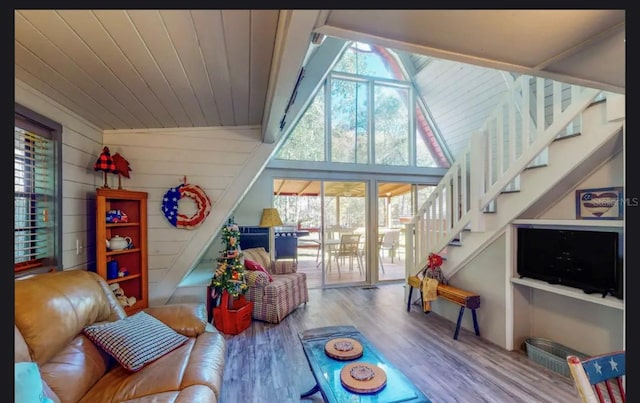 recreation room with hardwood / wood-style floors, lofted ceiling, and wooden walls