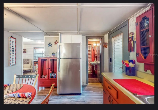 kitchen with light hardwood / wood-style floors and stainless steel refrigerator