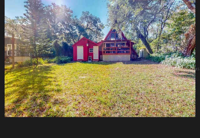 view of yard with a shed and a deck