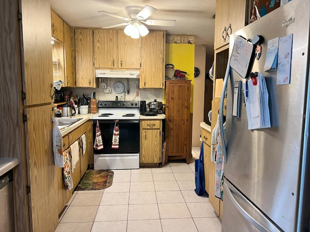 kitchen featuring appliances with stainless steel finishes, sink, ceiling fan, and light tile patterned flooring