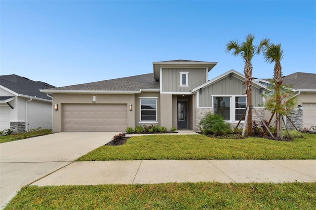 view of front facade with a garage and a front lawn