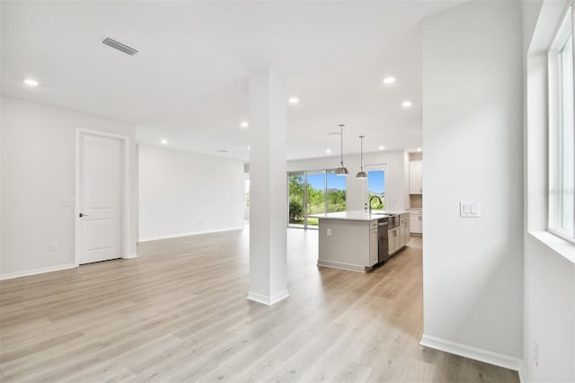 living room featuring sink and light hardwood / wood-style flooring