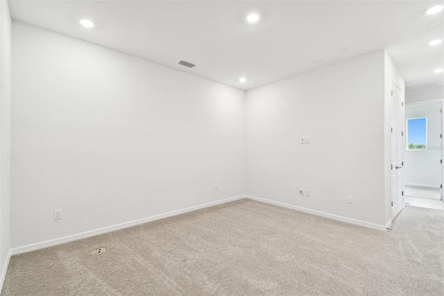 spare room with light colored carpet