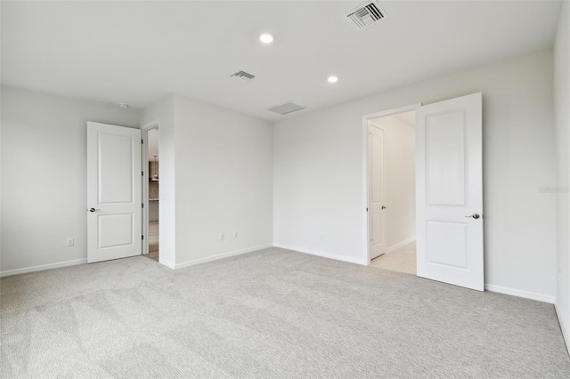 spare room with light colored carpet