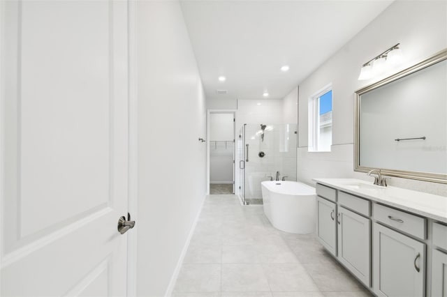 bathroom featuring tile patterned flooring, vanity, and independent shower and bath