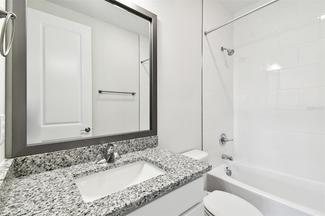 full bathroom with vanity, tiled shower / bath combo, and toilet