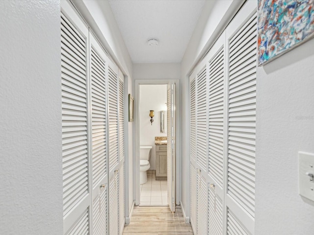 hallway with light hardwood / wood-style flooring