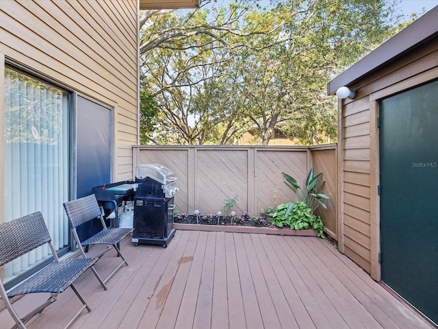 wooden deck featuring a grill