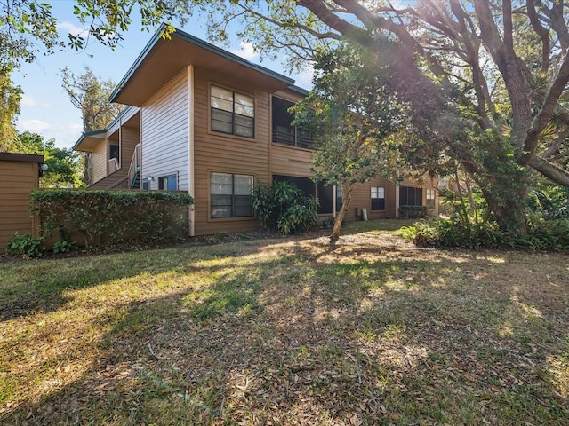 rear view of property with a lawn