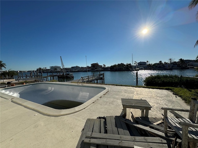 view of pool featuring a water view and a dock