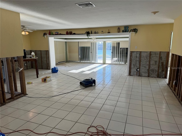 tiled empty room with ceiling fan