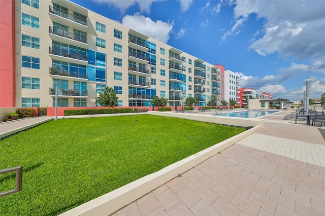 view of building exterior featuring a community pool