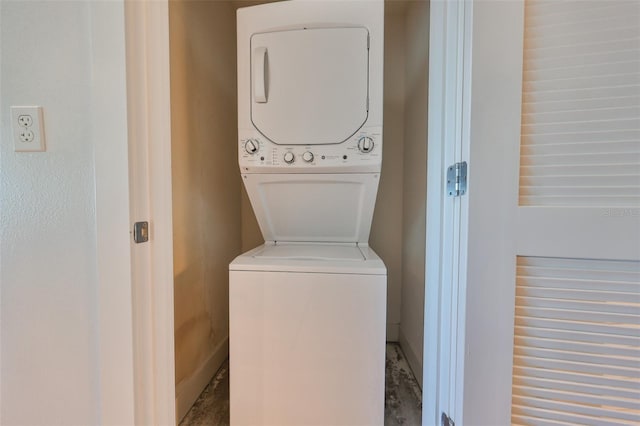 laundry room featuring stacked washer / drying machine