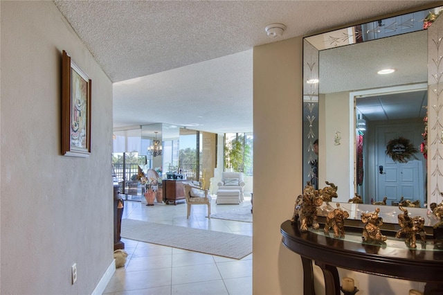 hallway with a healthy amount of sunlight, light tile patterned flooring, and a textured ceiling