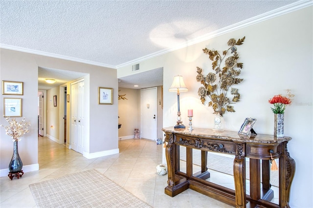 corridor with light tile patterned floors, a textured ceiling, and ornamental molding