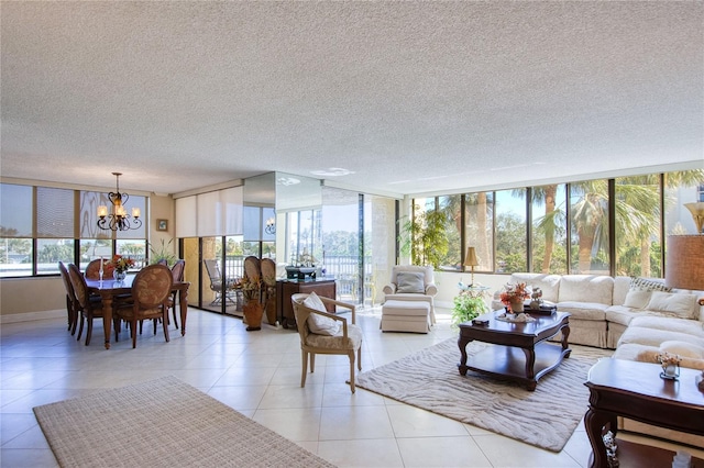 living room with a textured ceiling, an inviting chandelier, and plenty of natural light