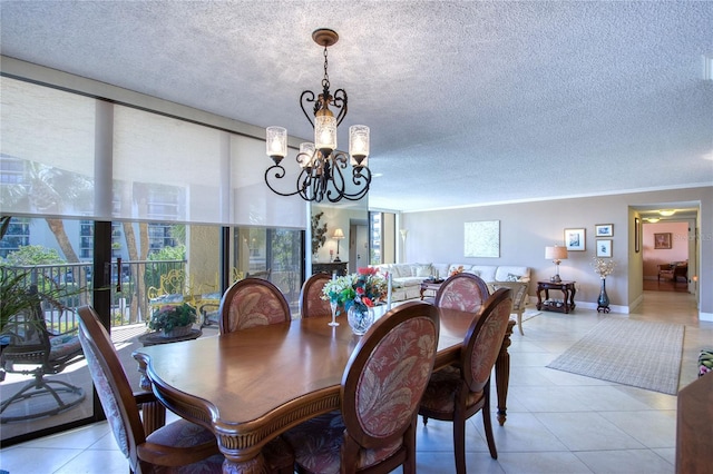 dining area with crown molding, a textured ceiling, and a notable chandelier