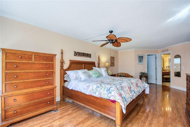 bedroom featuring ceiling fan, crown molding, a textured ceiling, and hardwood / wood-style flooring