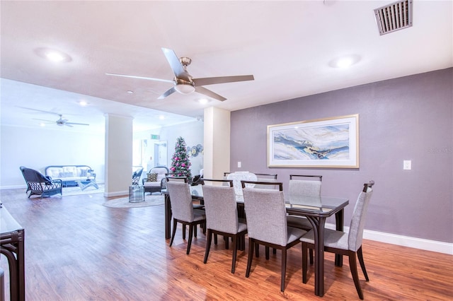 dining space with hardwood / wood-style flooring and ceiling fan