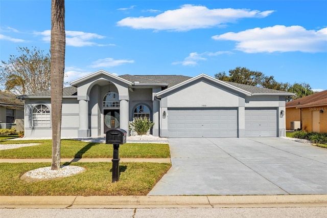 single story home featuring central air condition unit, a front lawn, and a garage