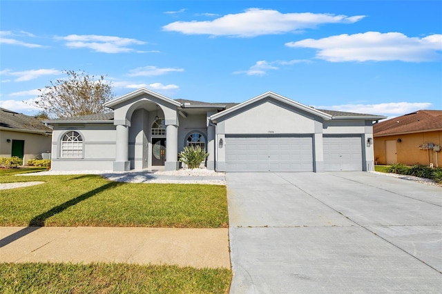 ranch-style home with a front yard and a garage