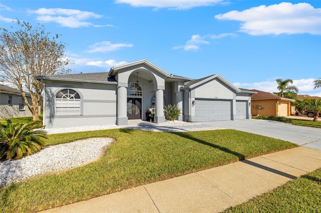 ranch-style house featuring a garage and a front lawn