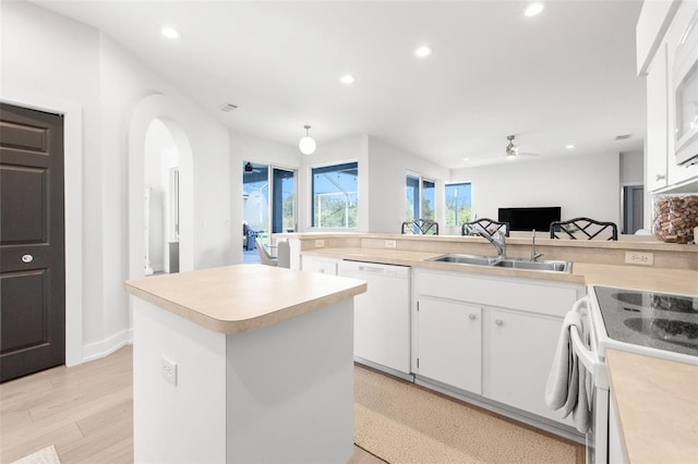 kitchen featuring white cabinetry, dishwasher, ceiling fan, sink, and light hardwood / wood-style flooring